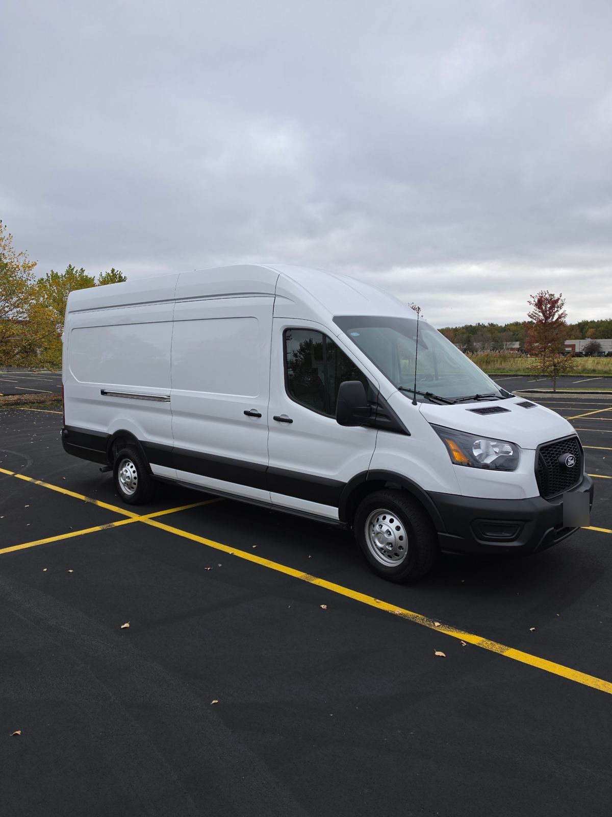 Side view of the white Transit 250 high roof van